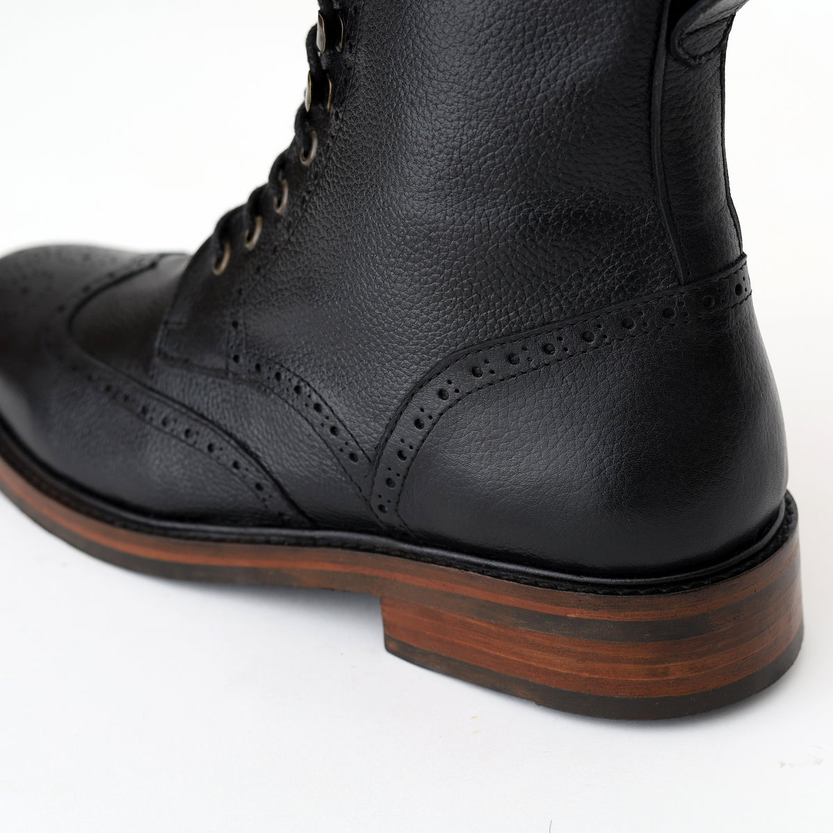 Irish Brogue Boot — Noir, détail du talon et des perforations brogue